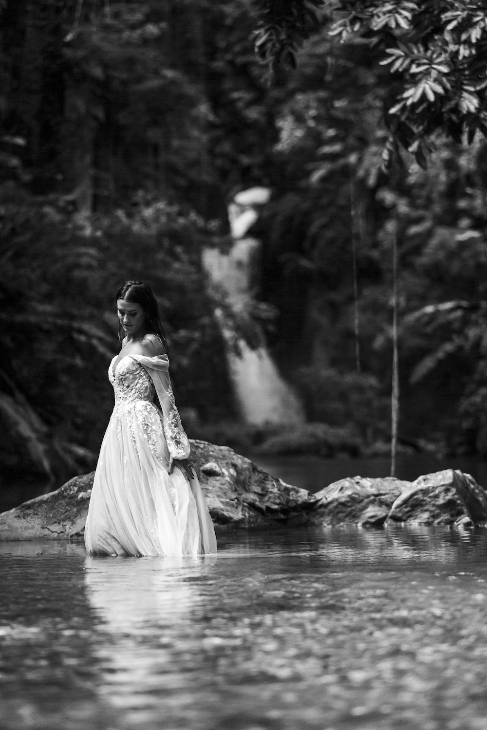 bride in water at waterfall