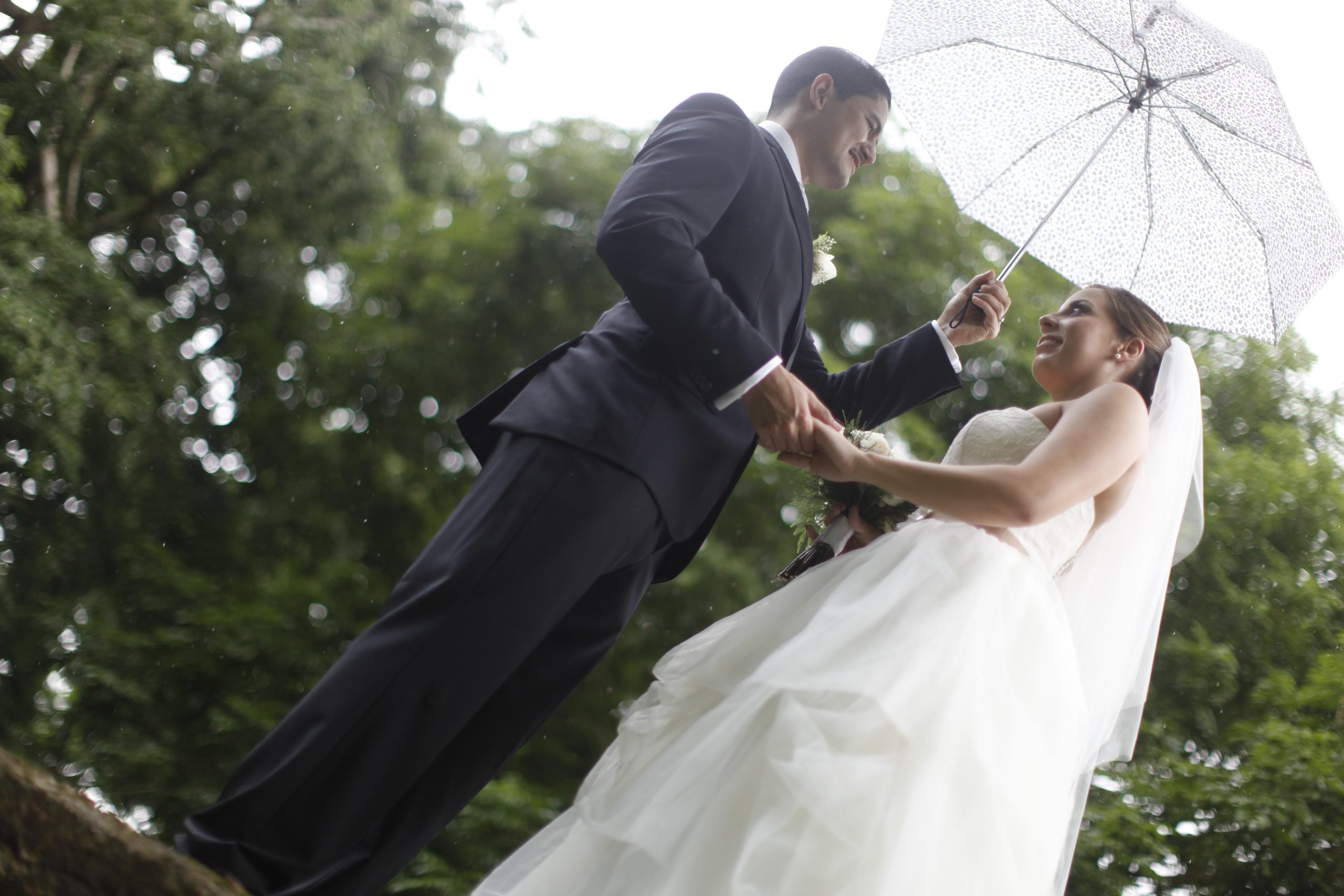 Bride and groom outside in rain